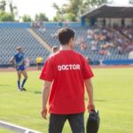20909691 - sports doctor, during the match, the players treat injuries