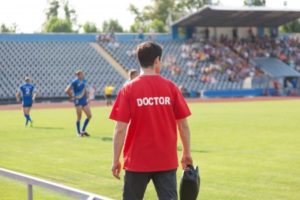 20909691 - sports doctor, during the match, the players treat injuries